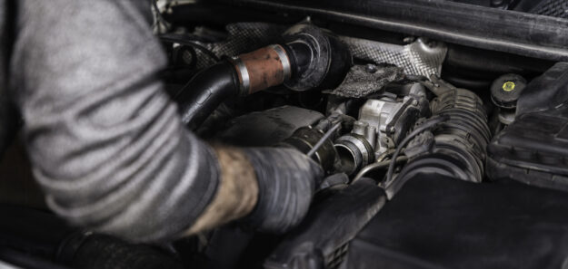Auto Mechanic Disassembling the Machine Part in the Car